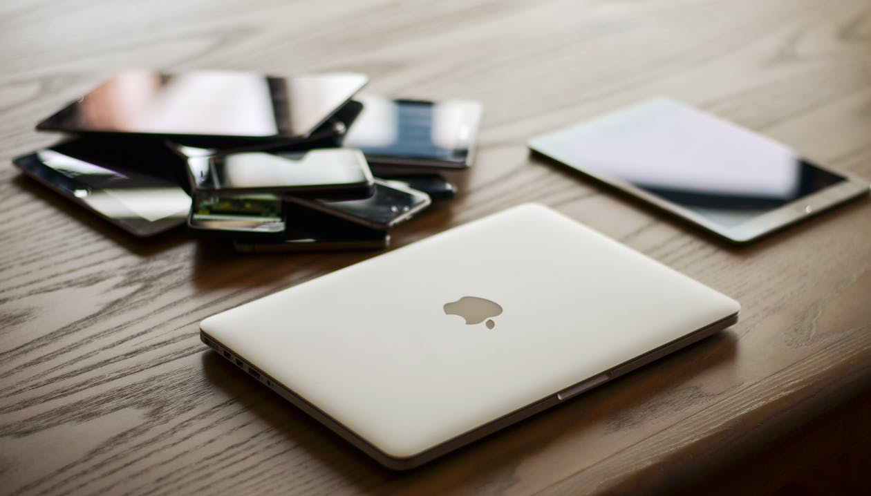 MacBook and iPad on desk showing Apple services and apps 2026
