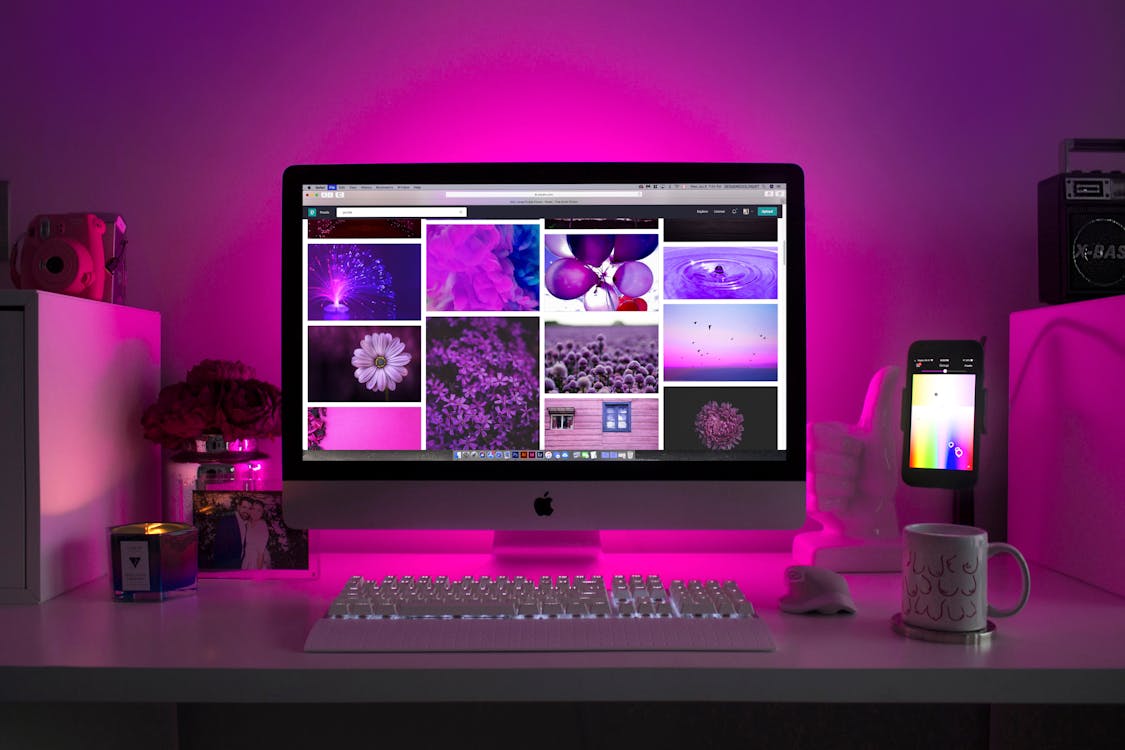 MacBook and iPhone on desk — Apple One bundle worth it 2026