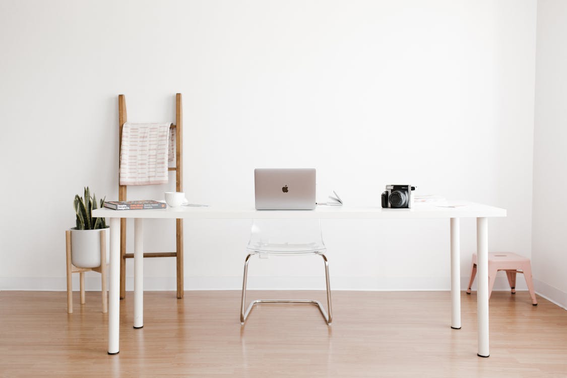Silver MacBook on white table — how to choose a laptop guide 2026