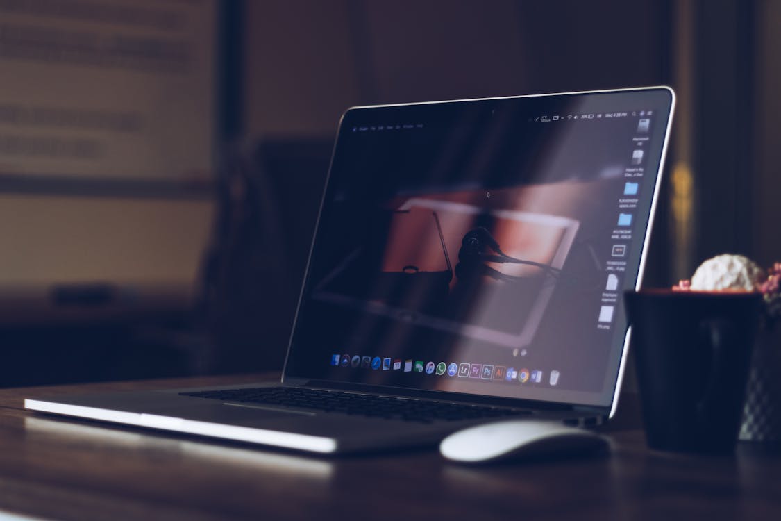 Person choosing between laptops in store — laptop buying decision 2026