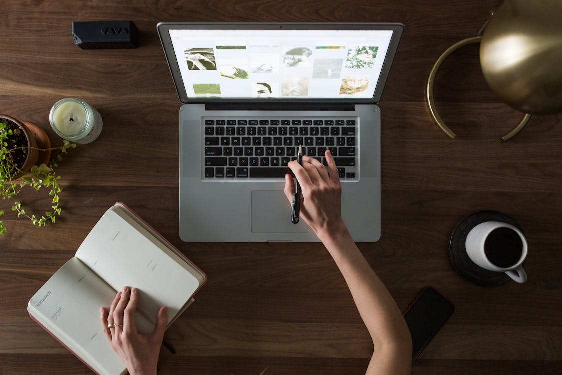 Person reviewing laptop specs and notes — laptop buying guide 2026